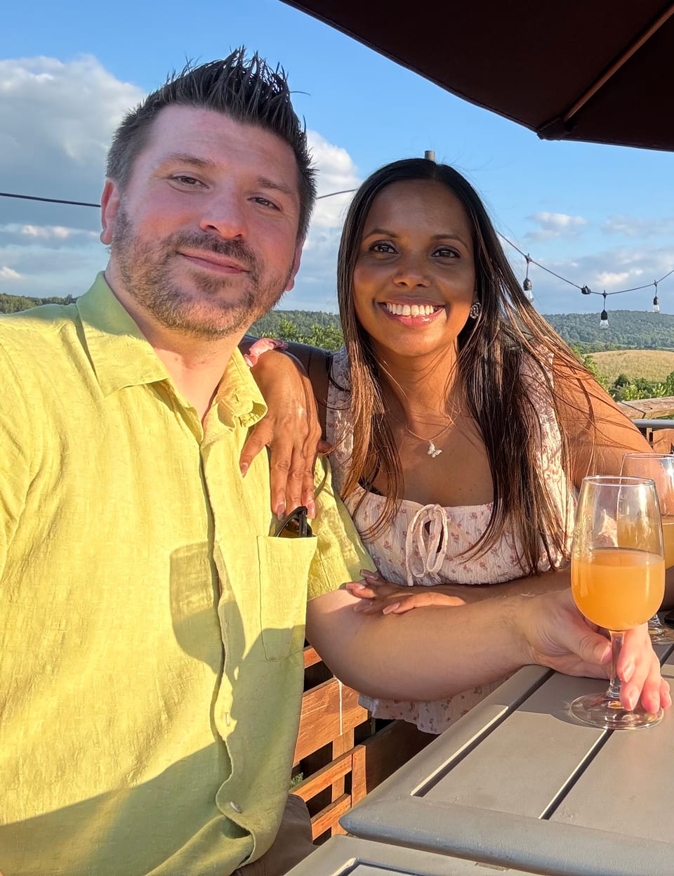 Doug Sillex and Shuva Begum, the founders of VibeKitchen, at an outdoor table at golden hour.